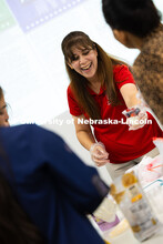 Zahraa Rida, a Lincoln-Lancaster County Extension assistant, hands a fruit, granola and yogurt parfa