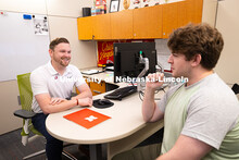 Adam Christiansen, Academic Navigator in the Explore Center, speaks with Jacob Behnk, a senior study