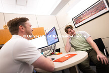 Adam Christiansen, Academic Navigator in the Explore Center, speaks with Jacob Behnk, a senior study