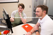 Adam Christiansen, Academic Navigator in the Explore Center, speaks with Jacob Behnk, a senior study