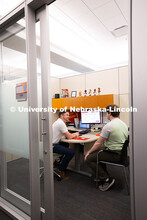Adam Christiansen, Academic Navigator in the Explore Center, speaks with Jacob Behnk, a senior study