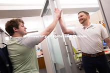 Adam Christiansen, Academic Navigator in the Explore Center, gives a high five to Jacob Behnk, a sen