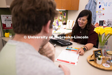 Selma De Anda Gallegos shares information about the Explore Center with Jacob Behnk, a senior studyi