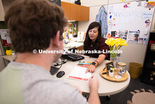 Selma De Anda Gallegos shares information about the Explore Center with Jacob Behnk, a senior studyi