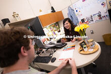 Selma De Anda Gallegos shares information about the Explore Center with Jacob Behnk, a senior studyi