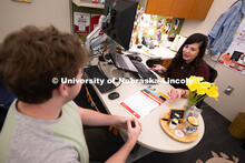 Selma De Anda Gallegos shares information about the Explore Center with Jacob Behnk, a senior studyi