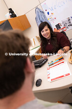 Selma De Anda Gallegos shares information about the Explore Center with Jacob Behnk, a senior studyi