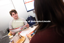 Selma De Anda Gallegos shares information about the Explore Center with Jacob Behnk, a senior studyi