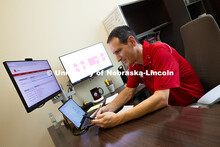 Parker Reed glances at his cell phone. Reed is an academic navigator for the College of Business, an