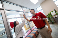 Mireu Ryu gives a high-five to Parker Reed, one of the academic navigators for the College of Busine