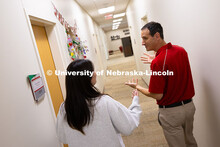 Parker Reed speaks with Mireu Ryu, a senior studying computer science, in the Business Advising and 