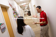 Parker Reed speaks with Mireu Ryu, a senior studying computer science, in the Business Advising and 