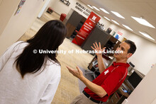 Parker Reed speaks with Mireu Ryu, a senior studying computer science, in the Business Advising and 