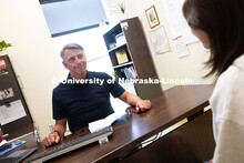 Dave Nebel speaks with Mireu Ryu, a senior studying computer science, in his office in Hawks Hall. N
