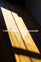 Sunlight falls on mismatched floorboards in the Art Chapel. The darker stained wood is original to t