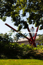 The beams of Old Glory, a sculpture by Mark Di Suvero, frame the cupola of Love Library on a warm, J