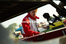 Ian Gouldie, a robotics engineering major and driver for the UNL Figure 8 Racing Team, peers into th