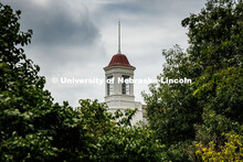 Summertime leaves frame Love Library’s cupola. Summer on City Campus. July 16, 2025. 
