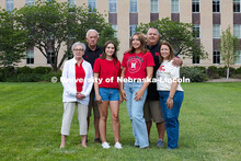Sisters Madison and Lauren Haring pose with their family in front of Love Library. The Haring family