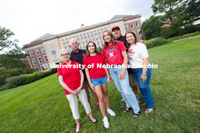 Sisters Madison and Lauren Haring pose with their family in front of Love Library. The Haring family