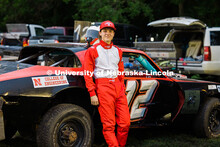 Ian Gouldie, UNL robotics engineering student, poses by the UNL Figure 8 racecar at the Saline Count