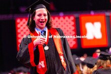 Computer Science major McKellan Clarke gives a thumbs up after receiving his diploma at the Universi
