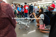 Sahana Sudarsan waves to a camera as she and her friends and teammates, Laakshitha Mittapalli (middl