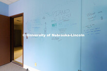 Students write their farewells on the wall of an office in the old Westbrook Music Building and expr