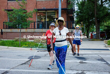 Sharon Cherono orientates through a crosswalk using her long cane during the mobility and orientatio