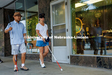 Lori Maestas, a teacher for the visually impaired, uses her guide cane to navigate downtown Lincoln 