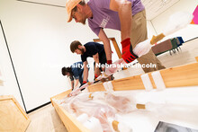 Natalie Yates (left), Associate Registrar for Collections and Exhibitions, lifts one piece of Niho K
