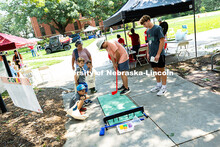 Jim Kolbo uses a plastic putter to aim for the target in a probability game at the 4-H booth during 
