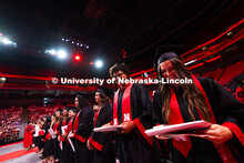 Graduates grin after receiving their diplomas. Summer Commencement ceremony in Pinnacle Bank Arena. 