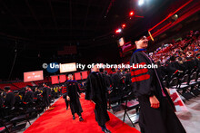 Wajdi Belgacem follows his adviser, Professor Jay Parsons, out of Pinnacle Bank Arena after receivin
