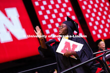Ma'Kiya Carter waves to a friend after receiving her diploma at the summer commencement ceremony. Su