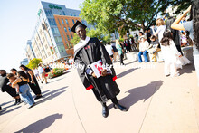 Oluseye Fakinlede poses for a photo in the Haymarket after the summer commencement ceremony. Summer 