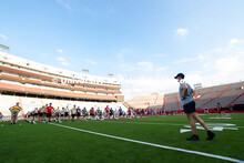 Drum majors lead the UNL Marching Band in balancing exercises during rehearsal on the field in Memor