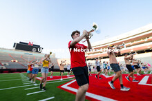 Eli Schuster, a senior mellophone player, marches during a warm-up exercise during rehearsal on the 