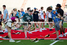 Vivianne Clark stretches with fellow tenor saxophone players Gionna Weber (left) and Oscar Thomas (r