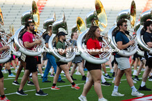 Tuba players march during a balance-building exercise during rehearsal on the field in Memorial Stad