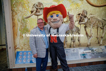 Vice Chancellor of Business and Finance, Mike Zeleny, poses for a photo with Herbie Husker during hi