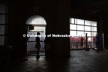 Student Orientation Leaders stand at the entrance to Gate 11 at Memorial Stadium, preparing to let f