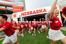 Students run onto the field during the Tunnel Walk into Memorial Stadium. The Tunnel Walk is for inc