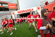 Students run onto the field during the Tunnel Walk into Memorial Stadium. The Tunnel Walk is for inc