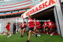 Chancellor Rodney Bennett claps for first-year students as they run into Memorial Stadium for the Tu