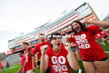 Students cheer after running into Memorial Stadium during the Tunnel Walk, before lining up to form 