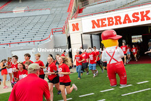 Lil Red watches as students run onto the field in Memorial Stadium for the tunnel walk. Tunnel Walk 