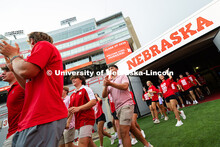 Students run onto the field in Memorial Stadium for the tunnel walk. Tunnel Walk into Memorial Stadi