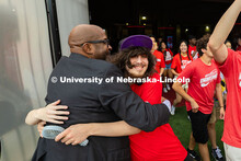 Chancellor Rodney Bennett gives a hug to two students as they run onto the field in Memorial Stadium