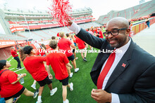 Chancellor Rodney Bennett waves a pom-pom to cheer on first-year students entering Memorial Stadium 